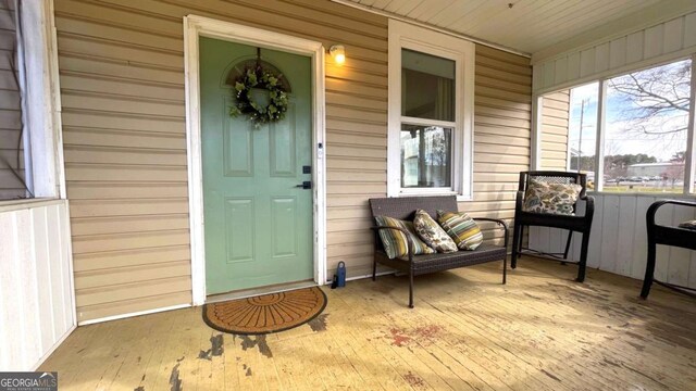 view of exterior entry with a porch