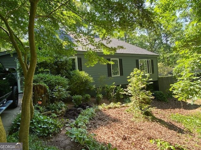 view of side of home with fence