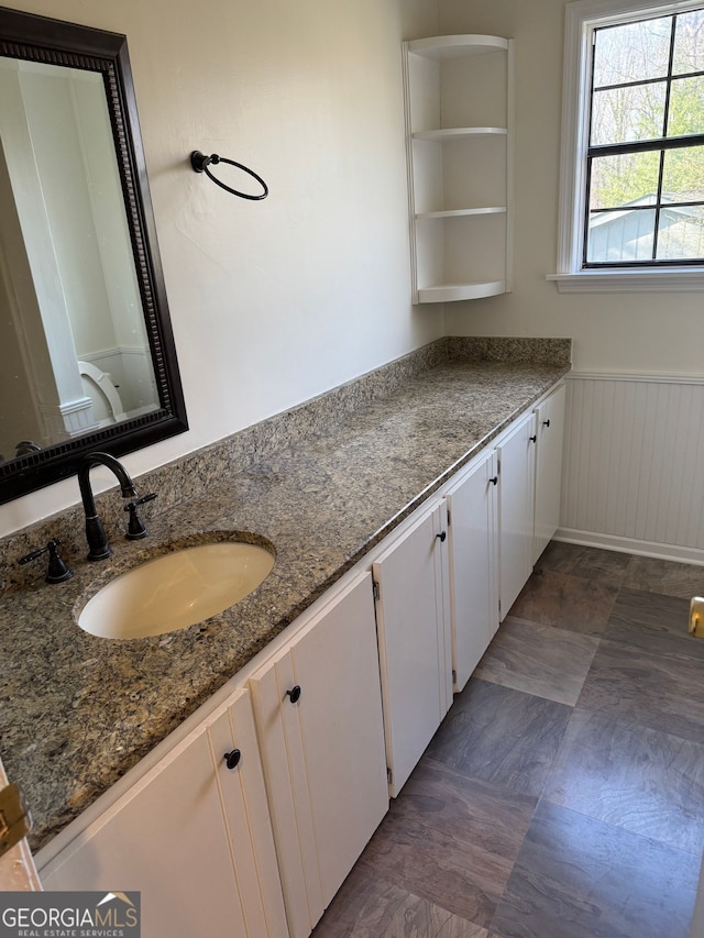 bathroom with wainscoting and vanity