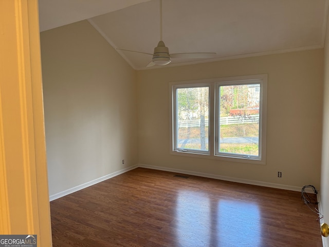 spare room featuring dark wood-type flooring and baseboards