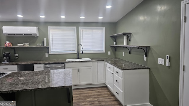 kitchen featuring open shelves, a wall mounted air conditioner, dark stone countertops, stainless steel dishwasher, and a sink