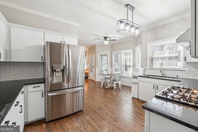 kitchen with dark wood-type flooring, a ceiling fan, a sink, stainless steel fridge, and crown molding