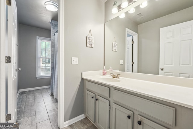 bathroom featuring vanity, baseboards, and visible vents