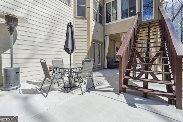 view of patio featuring stairs and outdoor dining space