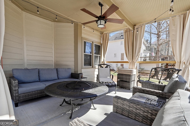 view of patio / terrace with an outdoor living space with a fire pit and a ceiling fan