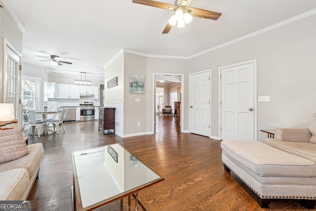 living room featuring baseboards, dark wood-type flooring, ceiling fan, and crown molding