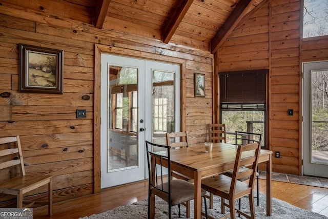 dining area featuring wooden ceiling, vaulted ceiling with beams, french doors, and hardwood / wood-style flooring