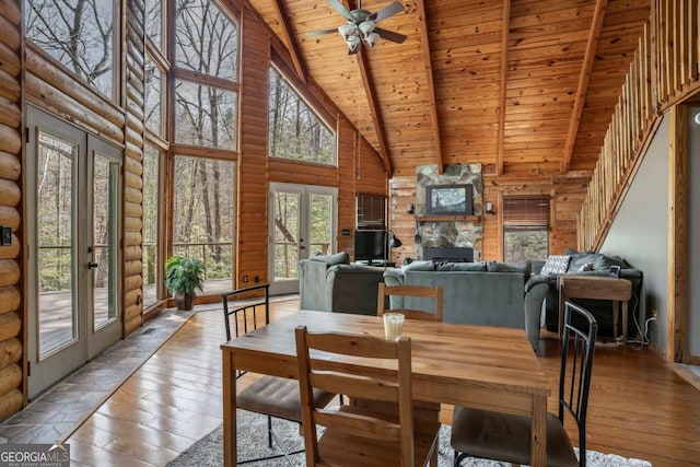 dining area featuring beamed ceiling, french doors, wooden ceiling, hardwood / wood-style flooring, and high vaulted ceiling