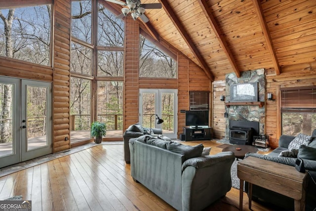 living area with high vaulted ceiling, french doors, wood-type flooring, wooden ceiling, and beamed ceiling