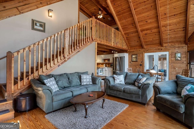 living room with stairway, wood finished floors, beam ceiling, and wooden ceiling