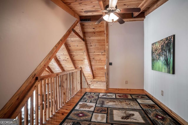 bonus room featuring lofted ceiling with beams, wood ceiling, wood finished floors, and a ceiling fan