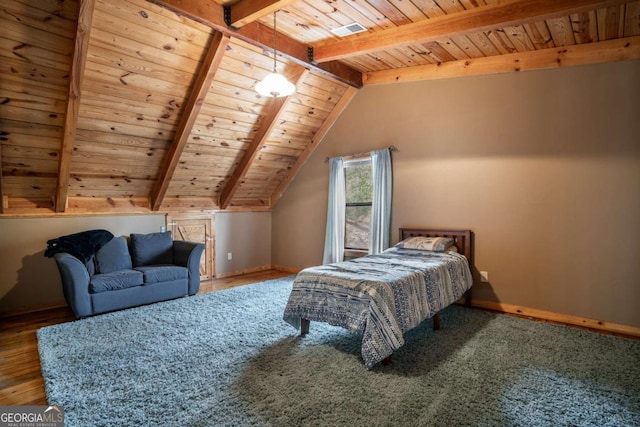 bedroom featuring lofted ceiling with beams, baseboards, wood finished floors, and wooden ceiling