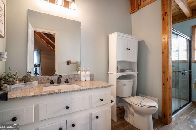 bathroom with vanity, toilet, and a stall shower