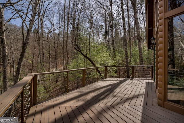 wooden terrace with a wooded view