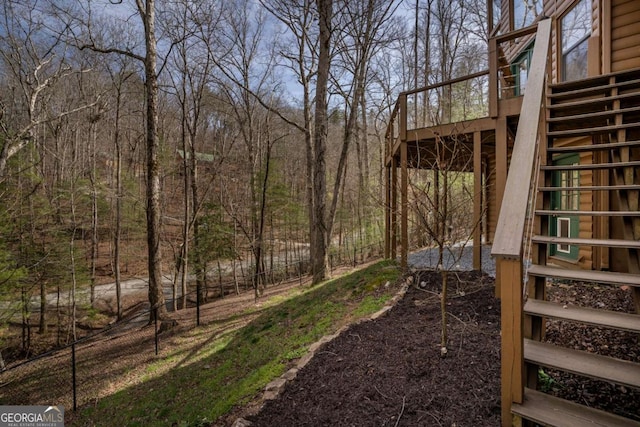 view of yard with stairs and a deck