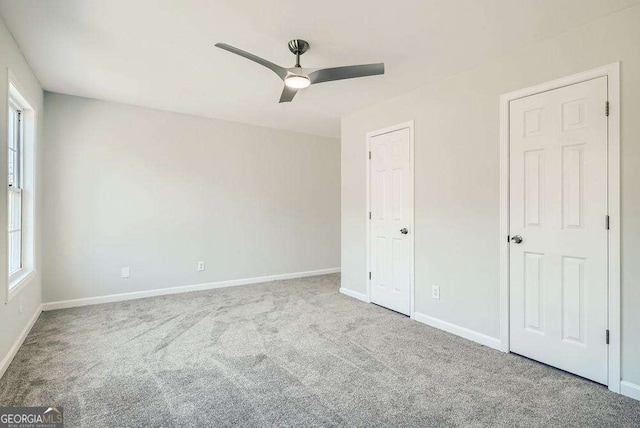 unfurnished bedroom with carpet floors, baseboards, and ceiling fan