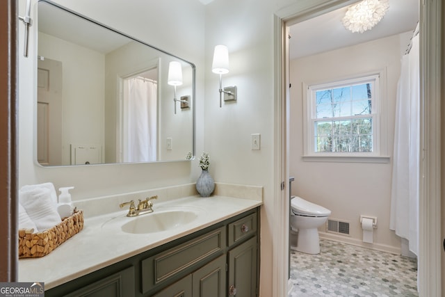 full bathroom featuring vanity, toilet, and visible vents