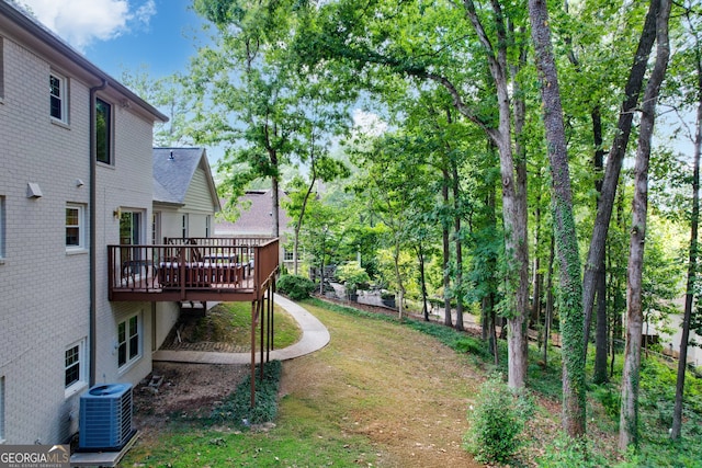 view of yard featuring a deck and cooling unit