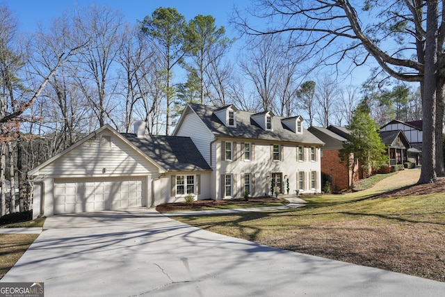 view of front facade with a front yard, an attached garage, brick siding, and driveway