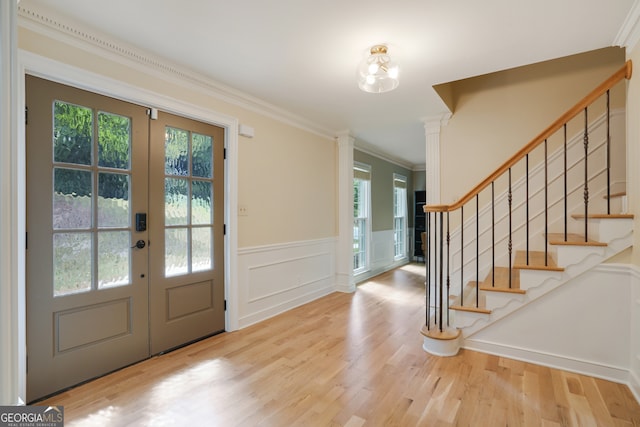 entryway featuring stairway, wood finished floors, and ornamental molding