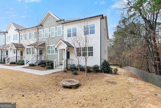 view of property featuring board and batten siding and fence