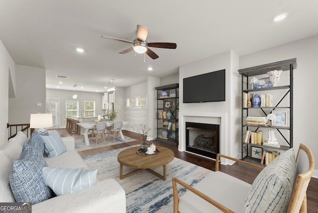 living area featuring recessed lighting, wood finished floors, and visible vents