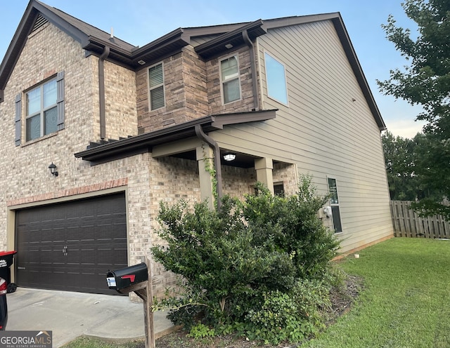 view of side of property featuring driveway, fence, an attached garage, brick siding, and a lawn
