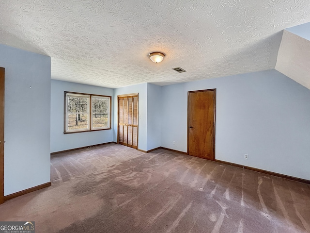 additional living space featuring carpet flooring, visible vents, and baseboards