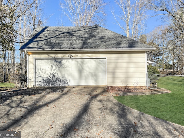 detached garage featuring fence