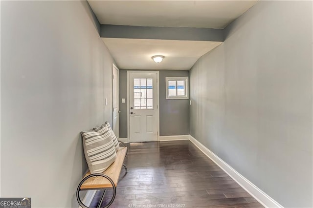 doorway to outside with baseboards and dark wood finished floors