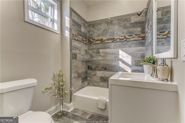 full bathroom featuring bathing tub / shower combination, toilet, vanity, and baseboards