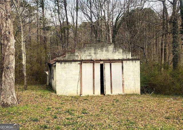 view of shed featuring a view of trees