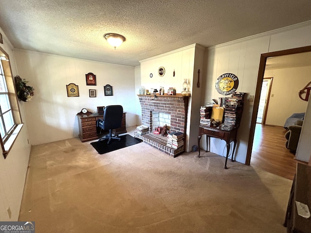 office with a fireplace, a textured ceiling, carpet, and ornamental molding