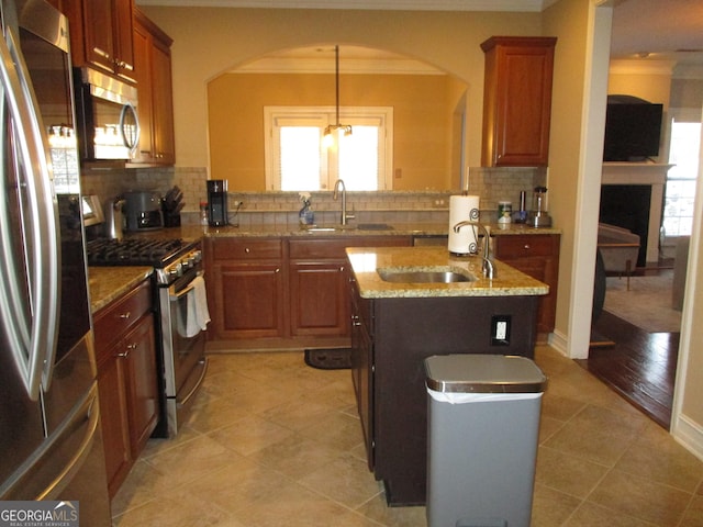 kitchen with appliances with stainless steel finishes, crown molding, and a sink