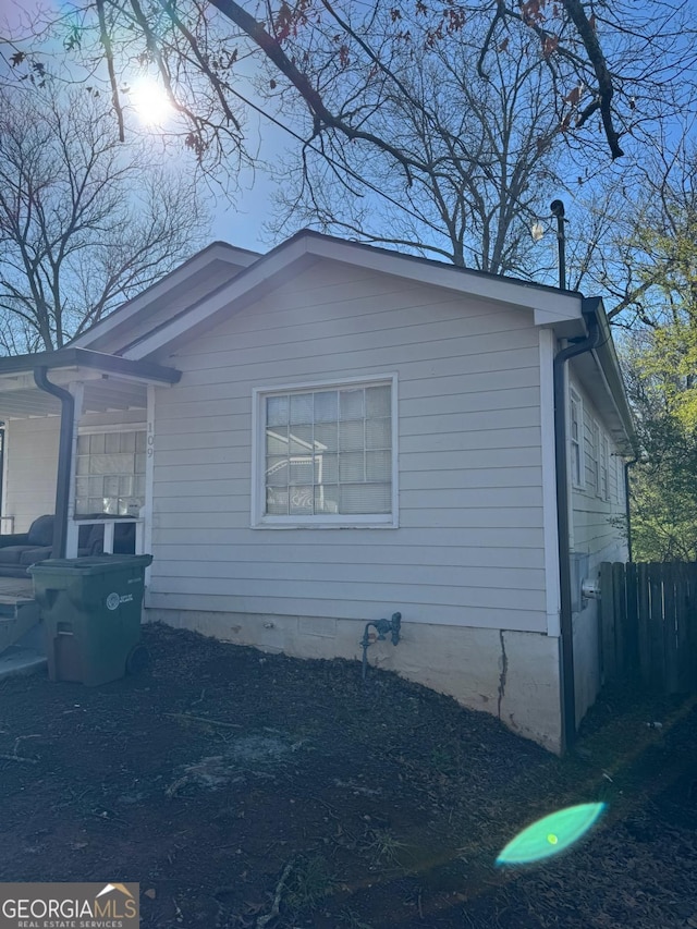 view of property exterior featuring fence