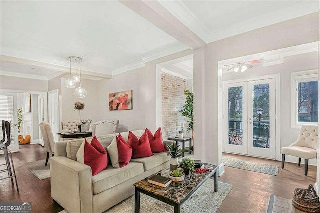 living area featuring wood finished floors, crown molding, and french doors