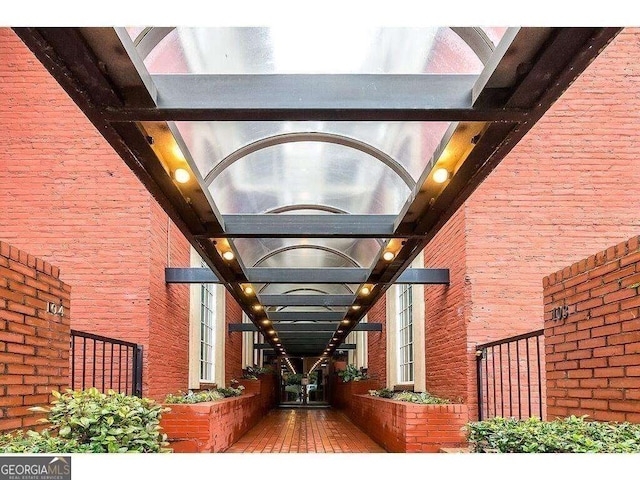 doorway to property featuring brick siding