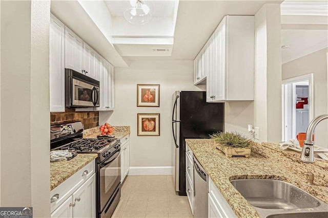 kitchen with white cabinetry, stainless steel appliances, and a sink