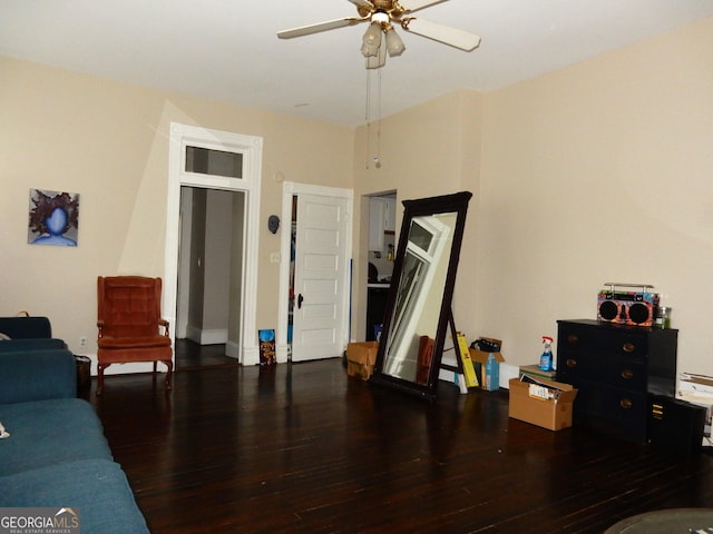 living room featuring a ceiling fan and wood finished floors