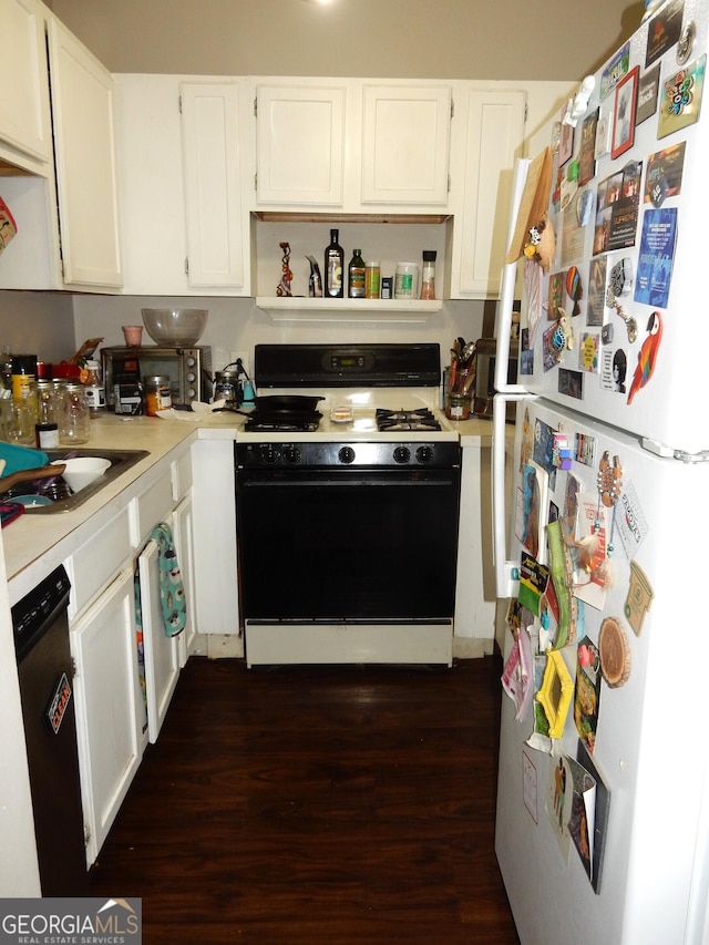 kitchen with light countertops, gas range oven, freestanding refrigerator, white cabinets, and stainless steel dishwasher