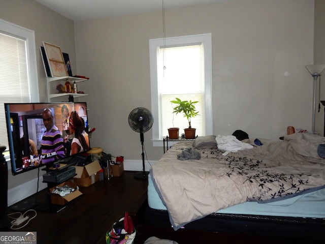 bedroom featuring baseboards and wood finished floors