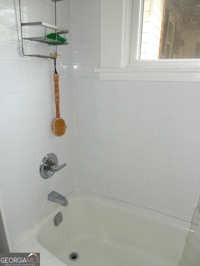 bathroom with shower / washtub combination