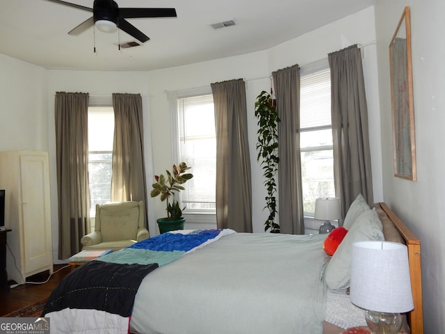 bedroom featuring visible vents, wood finished floors, and a ceiling fan