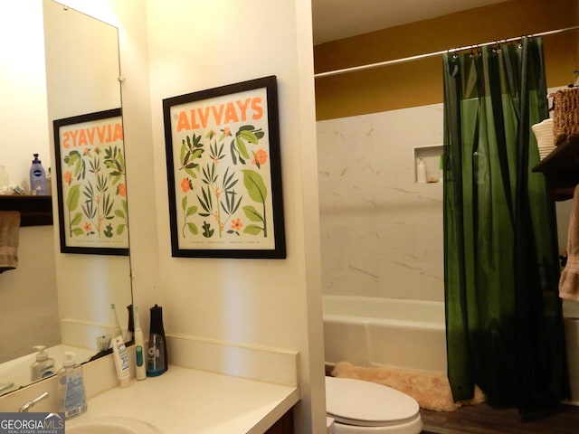 bathroom featuring vanity, toilet, and shower / bath combo with shower curtain