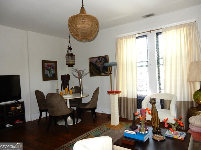 living area with wood finished floors and visible vents