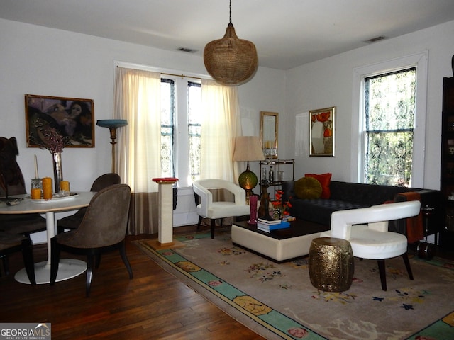 living room with visible vents and wood finished floors