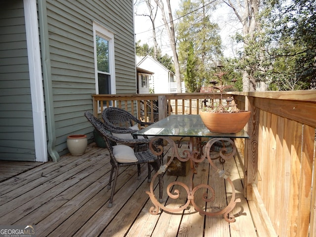 wooden deck featuring outdoor dining area