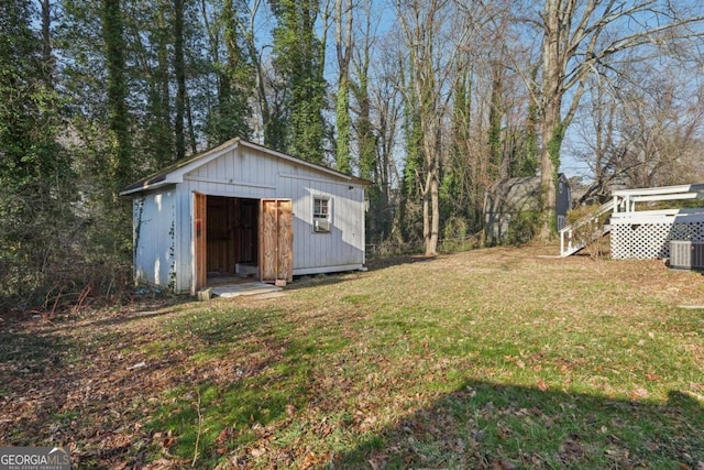 view of yard featuring cooling unit, an outdoor structure, and a shed