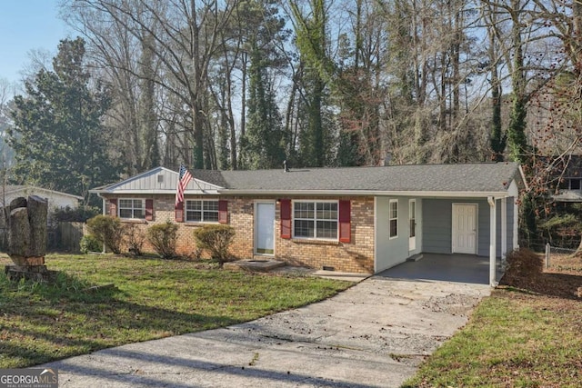 ranch-style house featuring an attached carport, a front yard, brick siding, and driveway