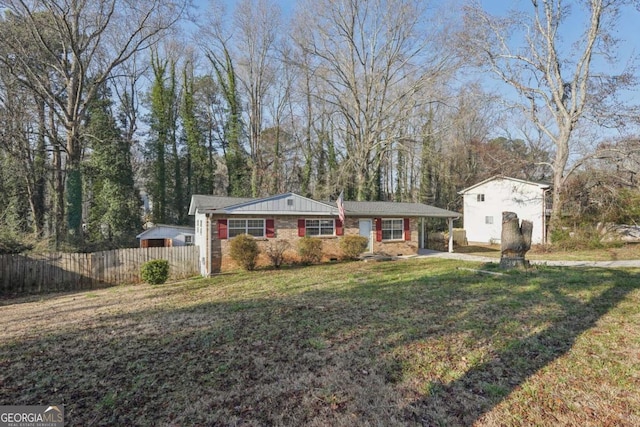 ranch-style house with brick siding, a front lawn, and fence